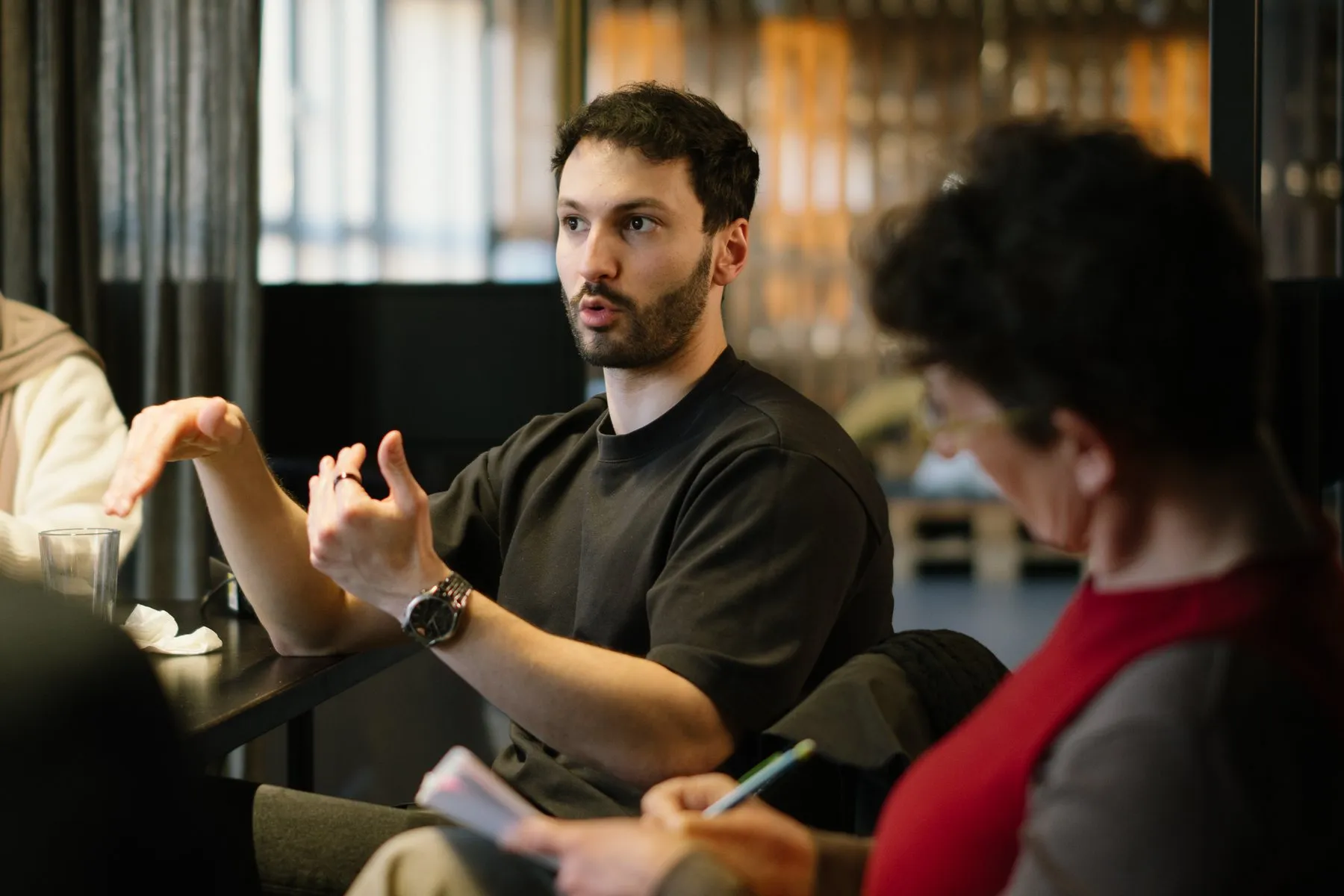 A founder explaining something with both hands, mid-sentence